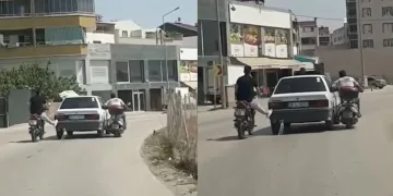 Bursa’da yolda kalan otomobili ayaklarıyla ittiler