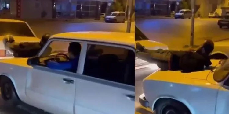 İki otomobilin arasına uzanıp, aracı ayaklarıyla itti