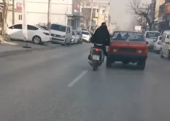 Bursa’da bozulan otomobili motosiklet ile itti