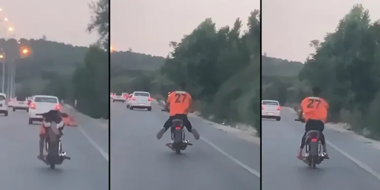 Motosikleti yatarak kullandı