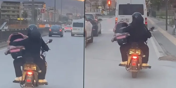 Motosiklet üzerinde bebeği pusetiyle taşıdı