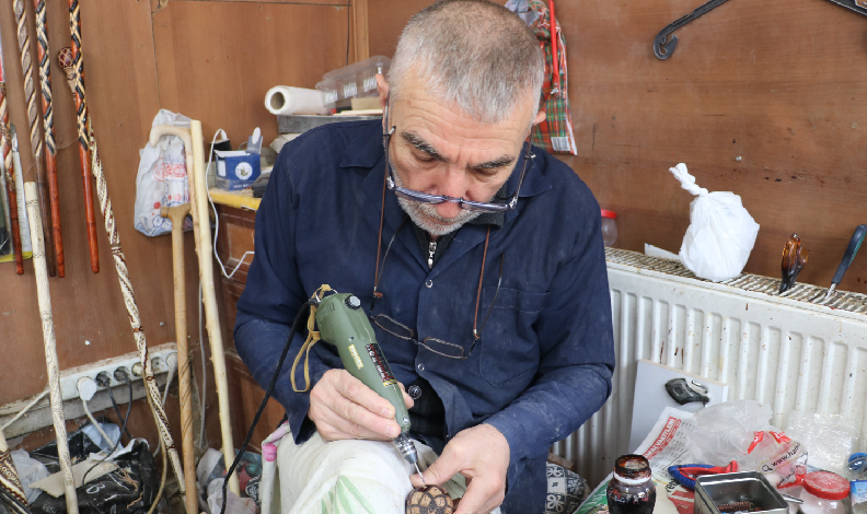 Kilim motiflerini bastona işliyor