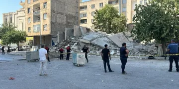 Yıkım sırasında bina iş makinesinin üzerine devrildi