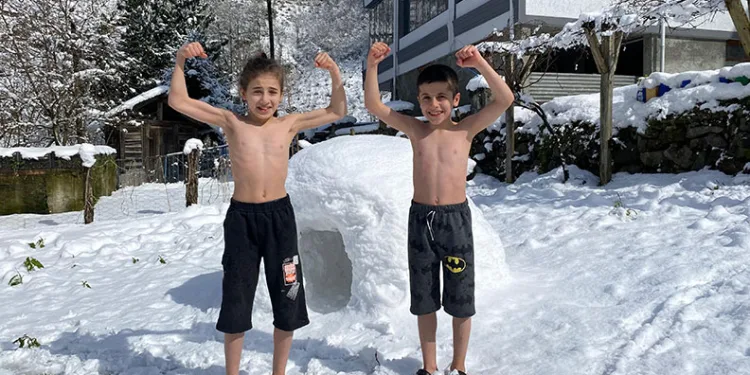 Kardeşlerin kar üzerinde güreş antrenmanı