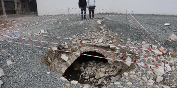 Depremde yıkılan binanın arazisinde yaşanan göçükle tarihi su kanalı ortaya çıktı