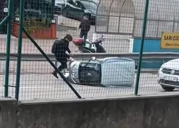 Rüzgarın etkisiyle devrilen otomobile çevredeki vatandaşlar koştu